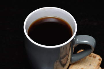 A gray mug filled with black coffee