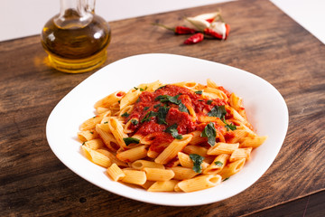 Penne pasta with tomato sauce. Traditional Italian dish, pasta with chili sauce. Italian food.