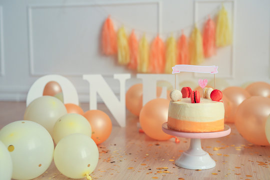 birthday decor photo on a white background. balls, tassel garland, cake, macaroons