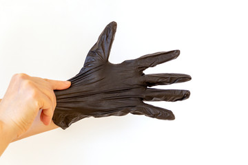 Woman puts on sterile medical gloves