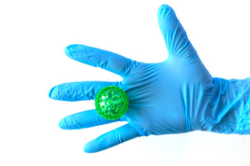 Hand in medical gloves with a virus stuck on the hand