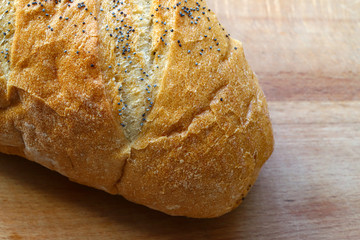 freshly baked bread on a wooden kitchen table, top view.
