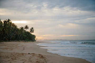 The coast of the Indian Ocean at dawn in Sri Lanka in March 2020. Calm beautiful water and azure blue waves