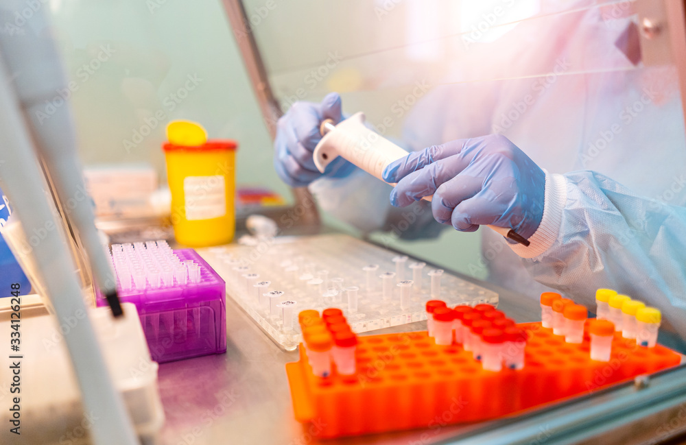 Wall mural research in laboratory. professional laboratory assistant taking blood test for dna research. health