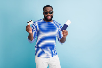 Photo of attractive dark skin guy traveler buy tickets with help of visa credit card wear sun...