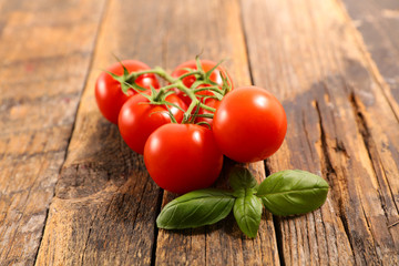 cherry tomato and basil on wood background