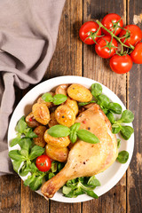 grilled chicken leg with potato and lettuce