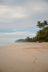 The coast of the Indian Ocean at dawn in Sri Lanka in March 2020. Calm beautiful water and azure blue waves