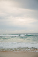 Fototapeta premium The coast of the Indian Ocean at dawn in Sri Lanka in March 2020. Calm beautiful water and azure blue waves
