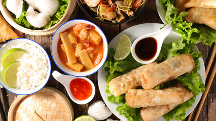 assorted of asian dishes- spring roll, chinese soup, rice and fried noodles