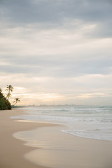 The coast of the Indian Ocean at dawn in Sri Lanka in March 2020. Calm beautiful water and azure blue waves