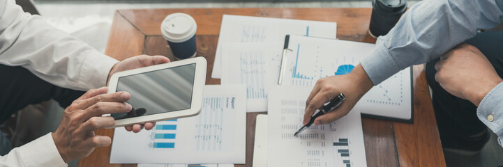 Business Corporate team brainstorming, Planning Strategy having a discussion Analysis investment researching with chart at office his desk documents and saving concept