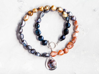 necklace from river pearls with pendant on gray
