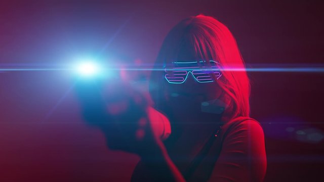Girl with blaster in the futuristic battle. Concept virtual reality, cyber game.