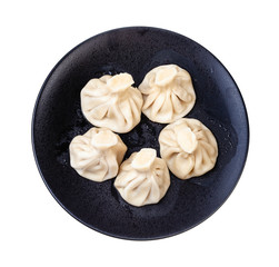 top view of five khinkali on black plate isolated