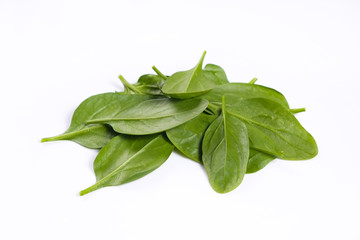 Clean eating concept. Heap of ripe juicy freshly picked organic baby spinach greens isolated on white background. Healthy diet for spring summer detox. Vegan raw food. Close up.