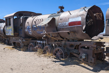Fototapeta na wymiar Rusty decayed train wrecks on the train cemetery near Uyuni, Bolivia