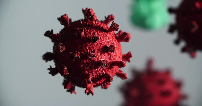 Coronavirus, COVID-19, Red virus with injection of a green and black vaccin (ink) on white-grey background