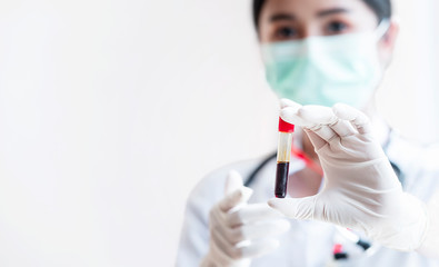 Nurse or doctor showing blood tube, closeup view.