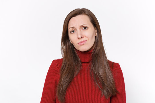 Dissatisfied upset young brunette woman girl in casual red clothes posing isolated on white background studio portrait. People sincere emotions lifestyle concept. Mock up copy space. Looking camera.