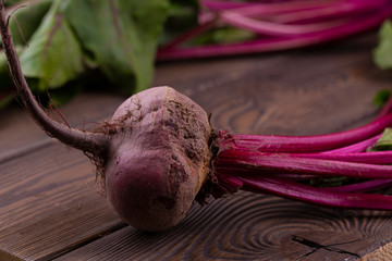 Organic Beetroot,red beetroot with herbage green leaves on rustic background.