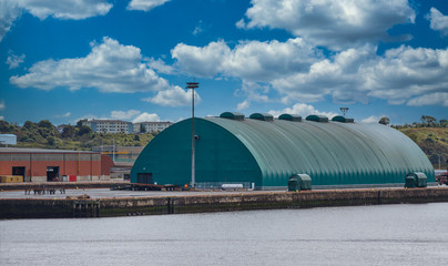 An old green, metal quonset hut on a pier in St John Canada