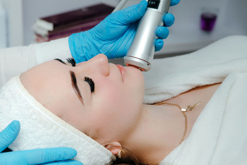Cosmetologist making oxygen mesotherapy to a woman at the luxury beauty salon. Concept of a...