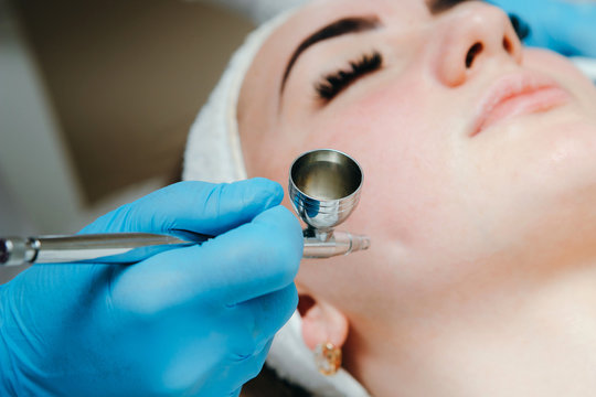 Woman receiving face treatment in beauty spa salon. Oxygen dermapen therapy. Skin treatment.