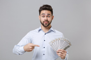 Young unshaven business man in light shirt isolated on grey background. Achievement career wealth...