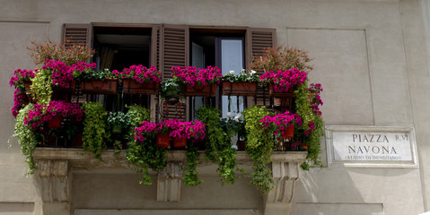 Fototapeta na wymiar Rome, Italy, May 05th 2015: A balcony full of flowers in Piazza Navona 