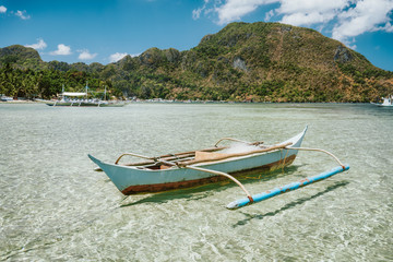 El Nido bay. Palawan island, Philippines. Filippino fishing boat in shallow water lagoon. Exotic travel destination