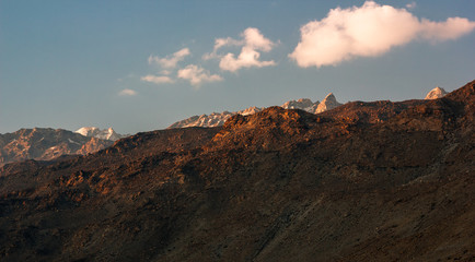 The Himalayan mountains on a clear evening with puffs of clouds in the sky as seen from the village...