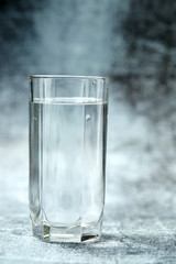 Glass of pure water on the grey background