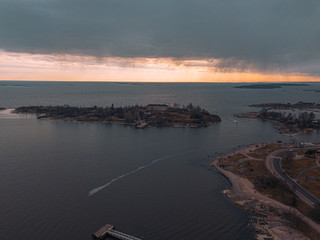 Helsinki islands. Scandinavian sea landscape. Beautiful sunset with reflection of clouds in the sea Aerial top down drone shot.