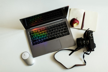 minimalistic desktop style, laptop on a table with a rainbow, stylish workspace