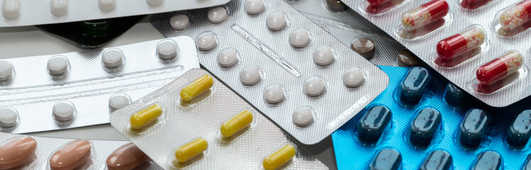 Vitamins and pills blister packs, close-up.