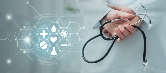 Doctor holding stethoscope in hands, medicine services
