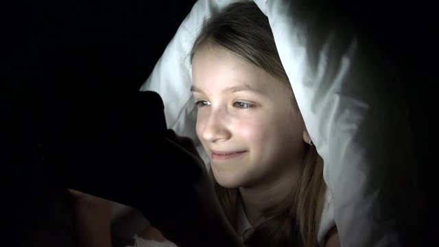 Kid Playing Tablet in Dark Night, Teenager Girl Browsing Internet in Bed, Child Not Sleeping