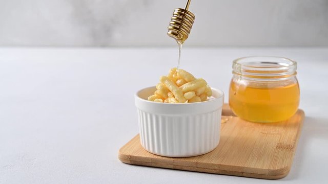 National food cuisine of the Middle East. Honey is pouring from a honey dipper onto a chuck chuck.. Copy space, 4K.