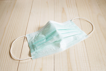 medical mask on wooden table for hygiene corona virus protection.