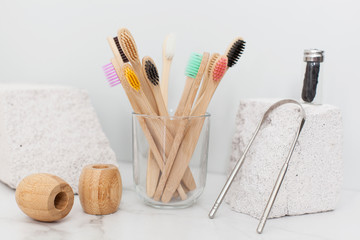 eco bath set for oral care without plastic. Family-friendly bamboo toothbrush, vegan dental floss and tongue scraper