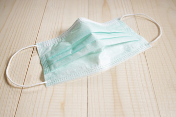 medical mask on wooden table for hygiene corona virus protection.