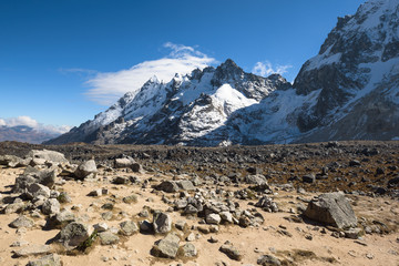 Rocky paths and green valleys surrounded by snowcapped mountains on the Salkantay Trek, Peru