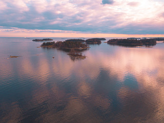 Helsinki islands. Scandinavian sea landscape. Beautiful sunset with reflection of clouds in the sea Aerial top down drone shot.
