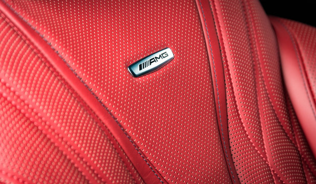 Sankt-Petersburg, Russia, January 12, 2018: Close up of Mercedes Benz car interior details, Affalterbach AMG logo in red perforated leather interior, on the car seat
