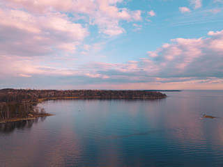 Helsinki islands. Scandinavian sea landscape. Beautiful sunset with reflection of clouds in the sea Aerial top down drone shot.