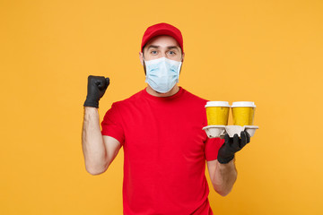 Delivery man in red cap blank t-shirt uniform mask gloves isolated on yellow background studio Guy employee hold takeaway cup of coffee Service quarantine pandemic coronavirus virus 2019-ncov concept.