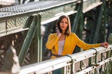 Beautiful woman walks on a bridge
