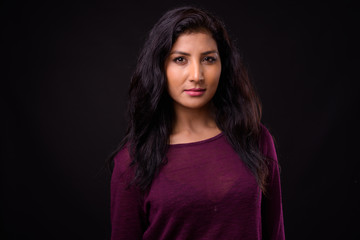 Face of young beautiful Indian woman looking at camera