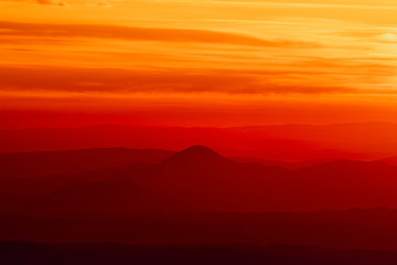 Tranquil landscape of layered mountains silhouettes during colorful sunrise, Slovakia